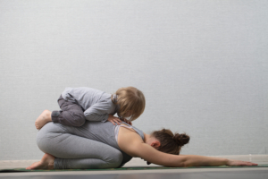 Hatha yoga fitness mother with baby